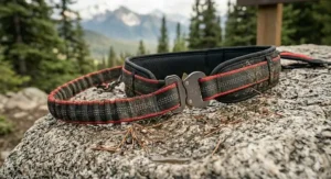 A close-up illustration of the durable, muddy hands-free running leash for trail running resting on wet granite rock, emphasizing its heavy-duty construction for all-weather Canadian conditions.